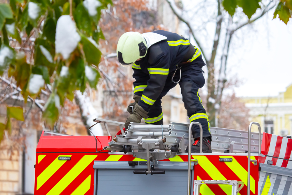 firefighter man works on his fire truck. fire safety service